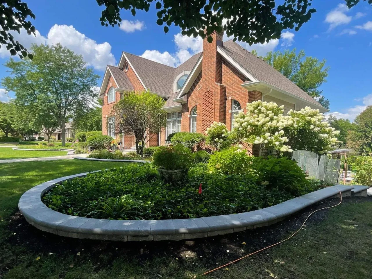 Front yard landscape with brick home curb appeal